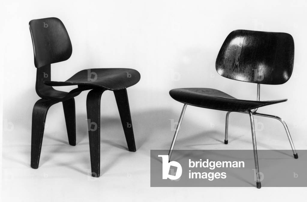 (LtoR) 'DCW' Dining Chair and 'LCM' Lounge Chair designed for Herman Miller by Charles Eames (1907-78) 1946 (wood and chrome-plated steel) (b/w photo)