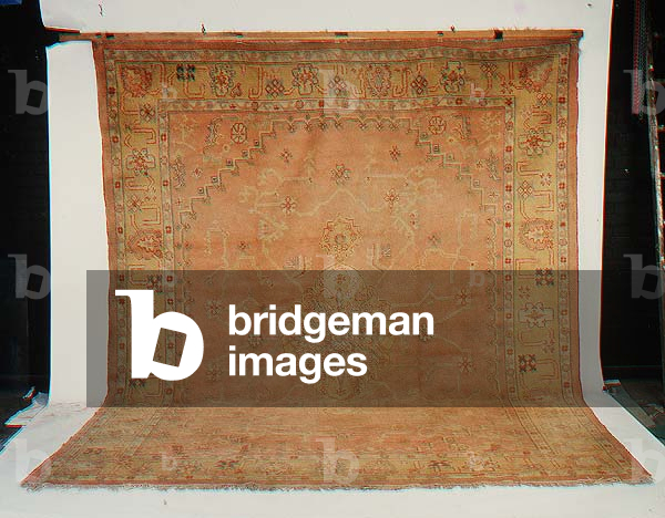 Turkish Carpet, the pale salmon-pink ground of angular vines centered by a saffron medallion and framed by stepped spandrels and flowerhead borders between floral guard stripes