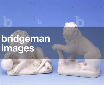 Bow white lion figures, one with his paw on a globe, the other seated, looking to his left c.1750 (ceramic)