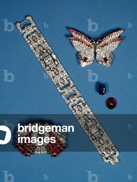 A diamond bracelet and two diamond and ruby brooches
