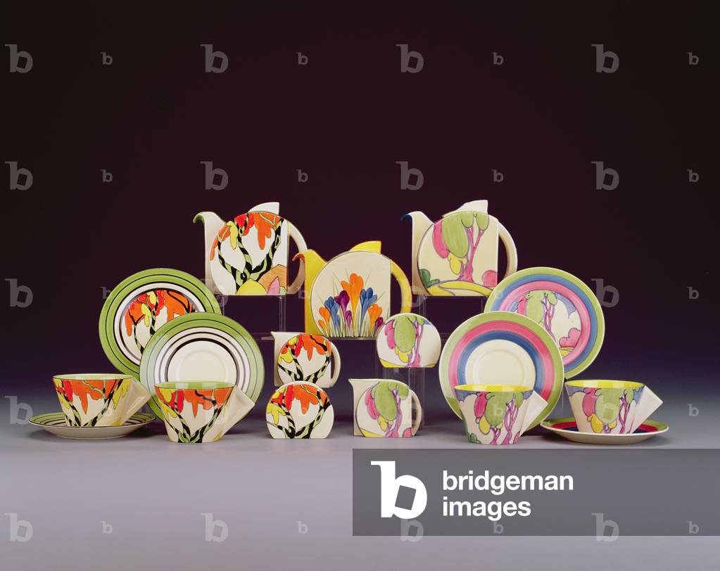 (LtoR) A 'Honolulu' pattern Stamford shape tea for two set, a 'Crocus' pattern Stamford shape teapot and cover and a 'Autumn Pastel' pattern Stamford shape tea for two set by Clarice Cliff (ceramic)