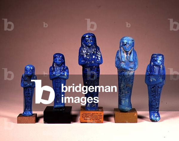 Five blue glazed Shabti figures with inscriptions for (LtoR) Pinedjem I; Queen Maat-Ka-Re I; Pinedjem II; Queen Henuttaui II; Nes-per-Nub; Egyptian, 21st Dynasty, c.1000 BC