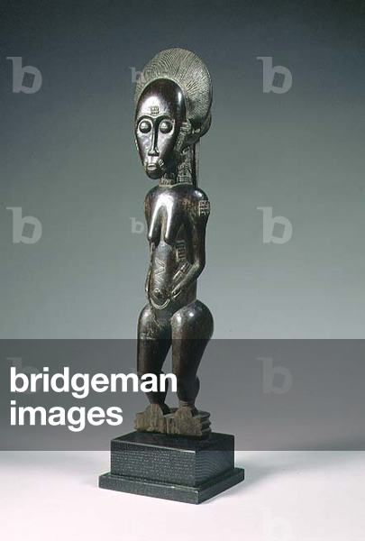 Female figurine with scarification of geometric design and bunned coiffure from the Baule tribe of the Ivory Coast (wood)