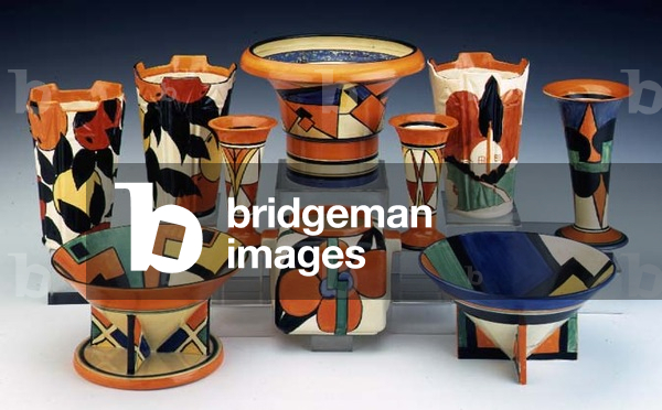 (LtoR) A pair of 'Oranges and Lemons' pattern vases, a 'Cubist' pattern Archaic series vase, a 'Farmhouse' pattern vase, a pair of 'Sunburst' pattern vases, a 'Castellated Circle' (Green Circle) vase, a geometrical design conical bowl, a 'Picasso Flower' (Orange colourway) pattern Stamford Jardiniere and a geometrical design conical bowl (ceramic)