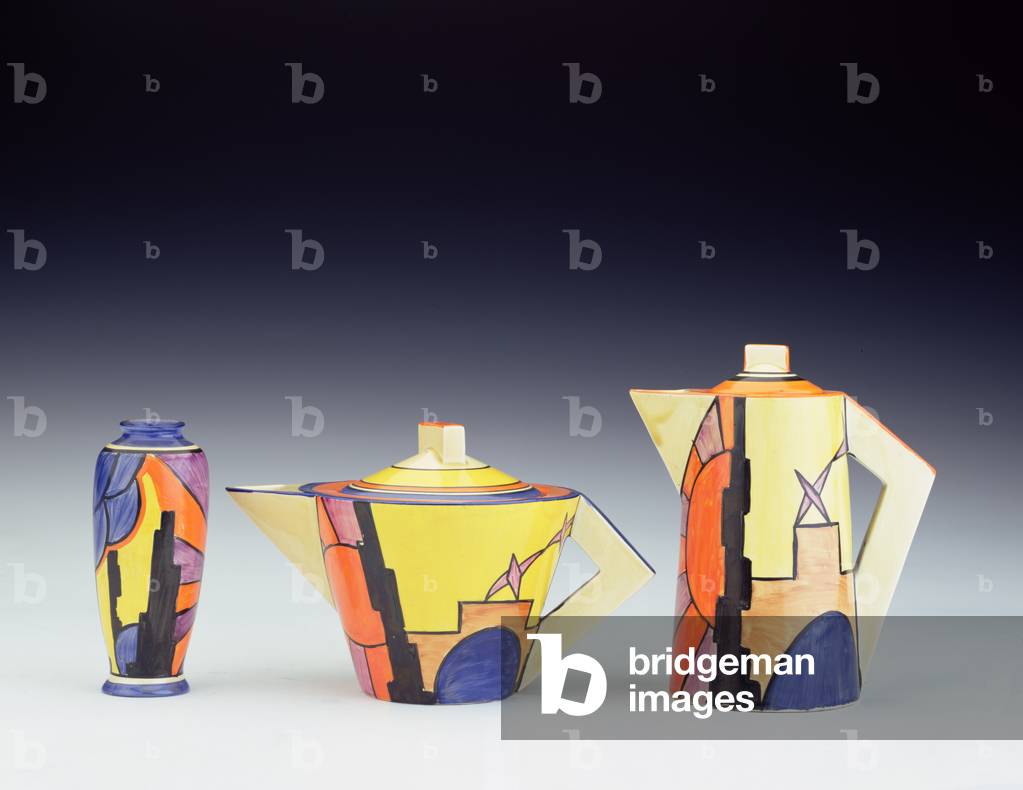 (LtoR) A 'Sunray' pattern vase, conical teapot and conical coffee pot, by Clarice Cliff (1899-1972) (ceramic)
