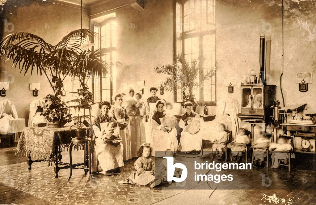 Nurses with Babies and Young Children in Ornate Ward , Paris, France , c.1890 (silver gelatin print)