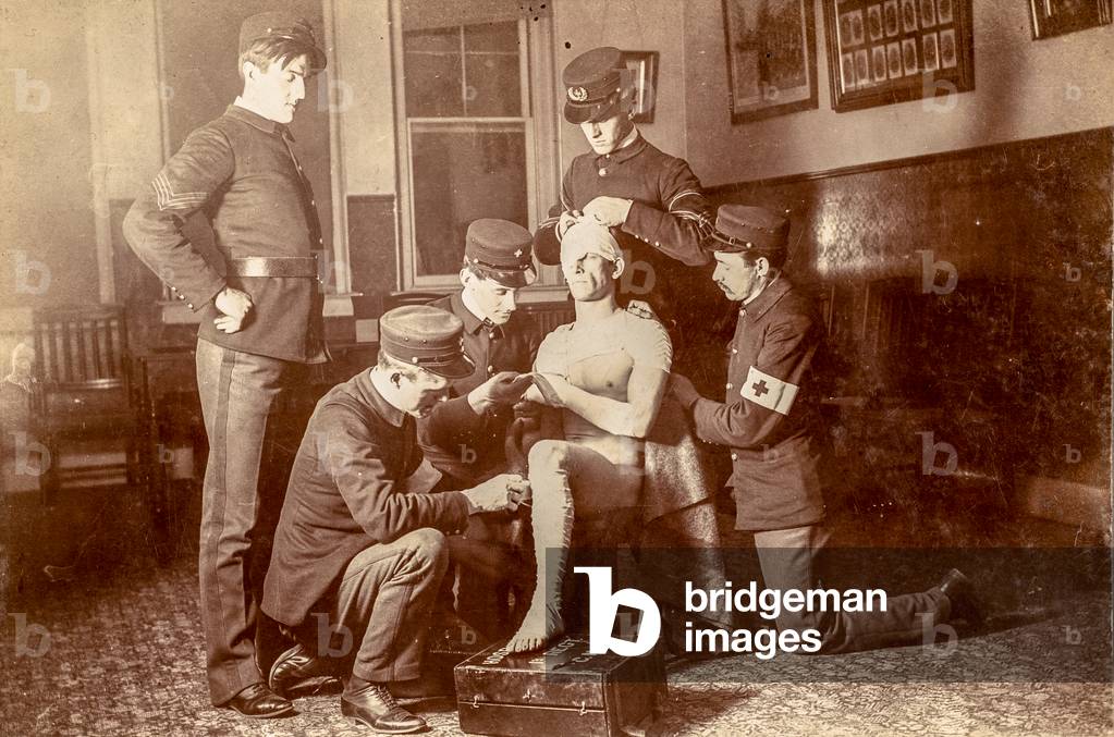 1st Regiment C.N.G. Demonstrating Proper Bandage Application #1, Connecticut, USA, c.1900 (silver gelatin print)