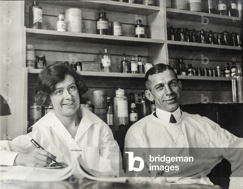 Male and Female Pharmacists Seated in Laboratory, c.1925 (silver gelatin print)