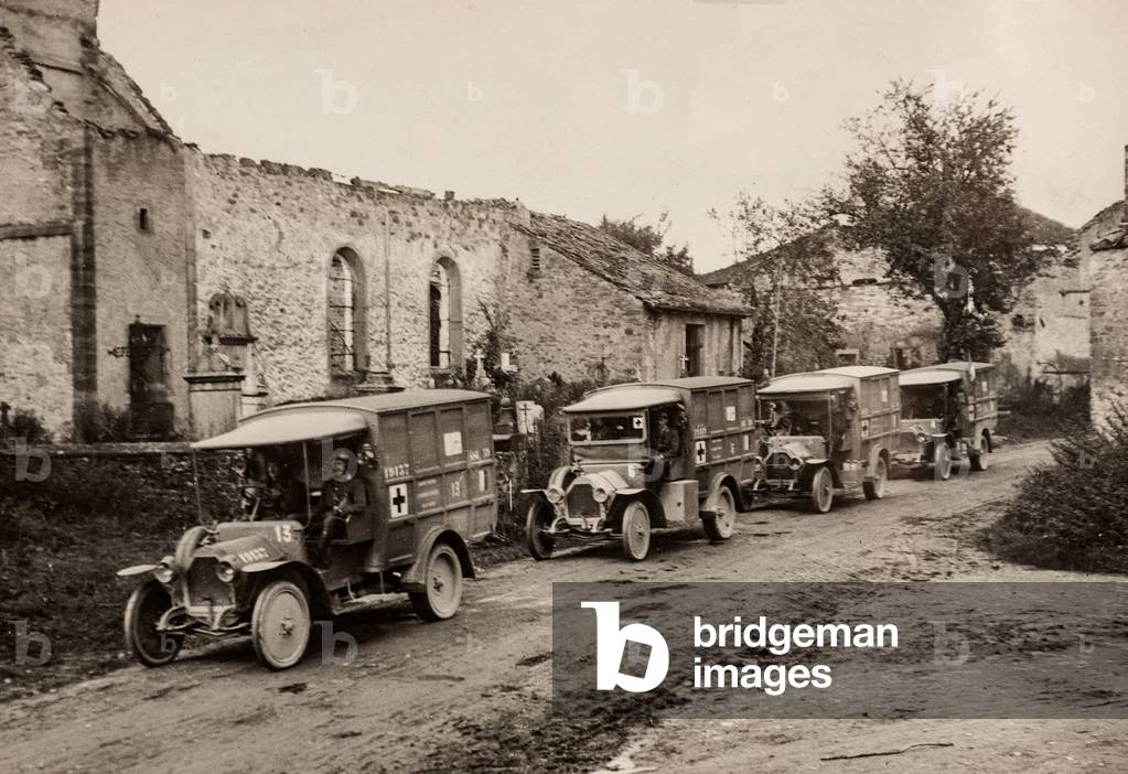 Four WWI French Ambulances Drive Past French Church Ruins, France, c.1916 (silver gelatin print)