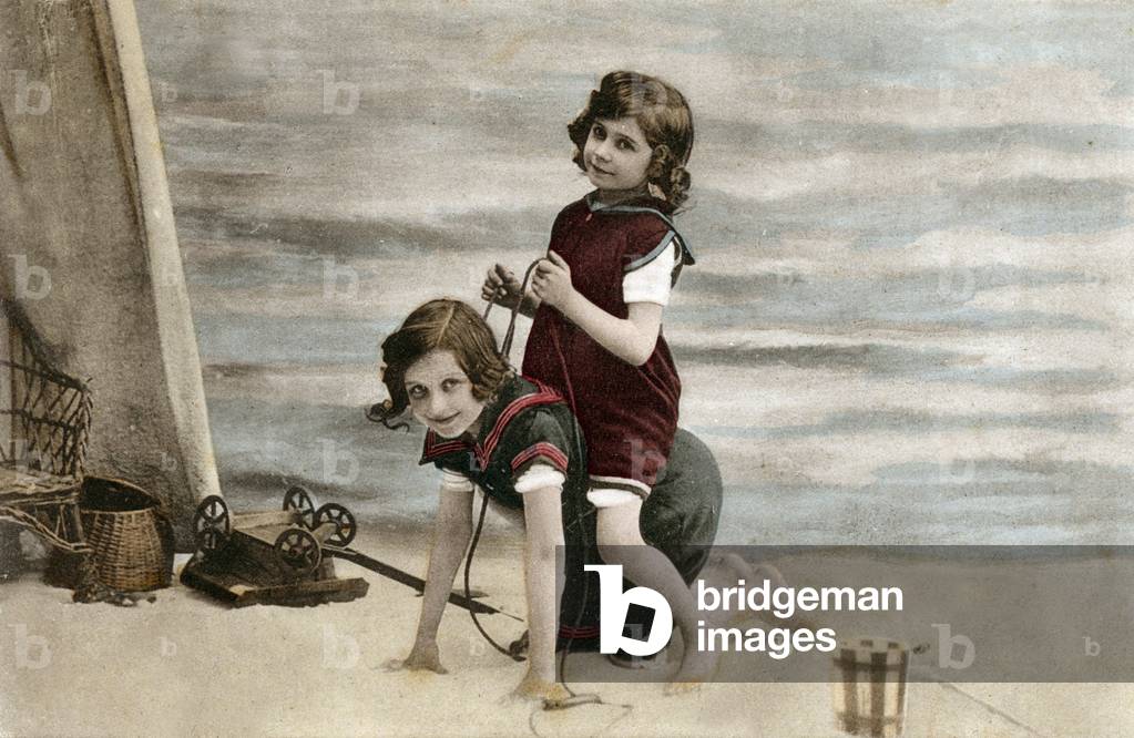 Two girls playing on the beach, postcard, c. 1910