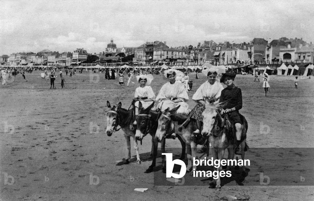 Les Sables d'Olonne (Vendee, France): a riding on a donkey on the beach, postcard, c. 1900