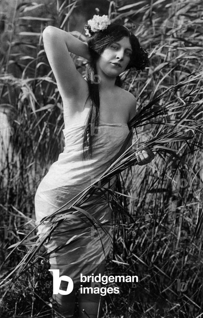 Young woman in a field, postcard, c. 1900 - 1910