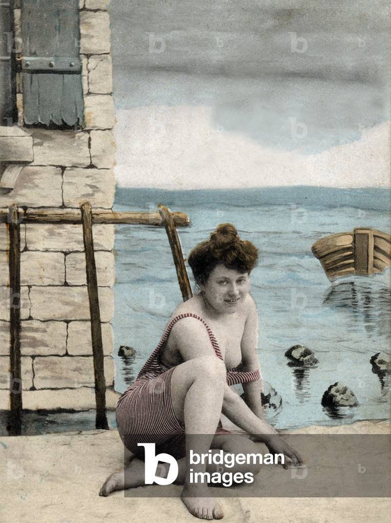 Woman wearing bathing suit on the beach, postcard, c. 1906