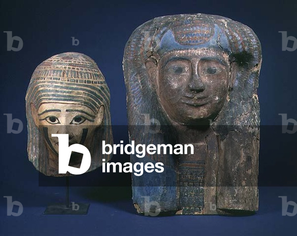 LtoR: mummy cartonnage head, Late Period, after 500 BC; sarcophagus lid painted with a woman wearing Mut head-dress, Late New Kingdom, 19th-20th Dynasties, c.1300-1200 BC, Egyptian (wood)