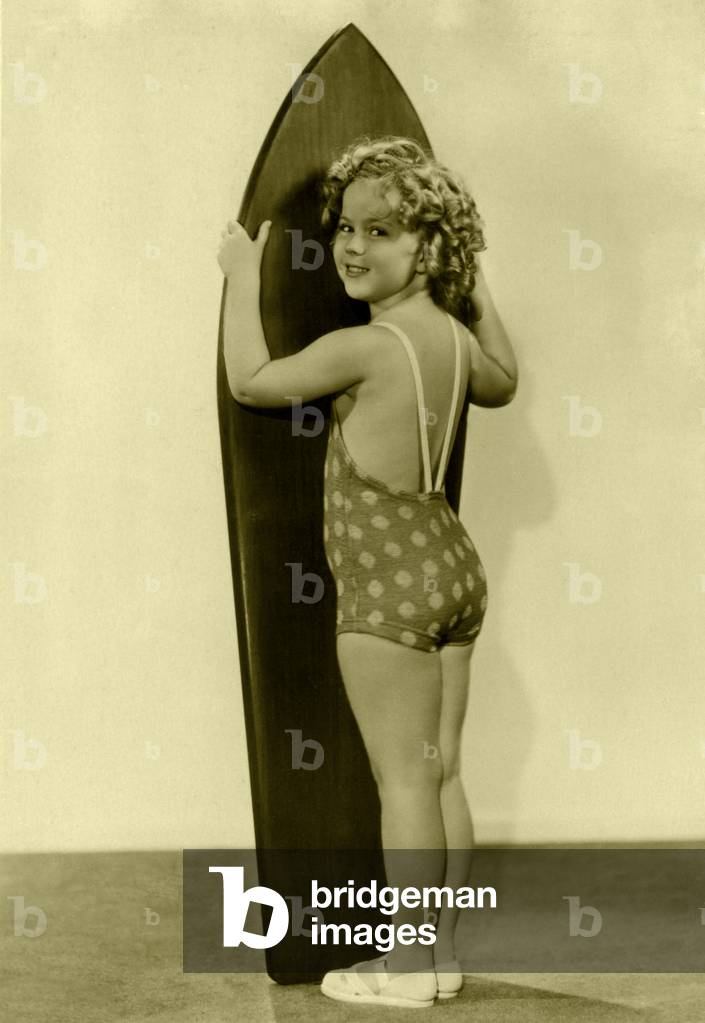 Shirley Temple with surfboard (b/w photo)