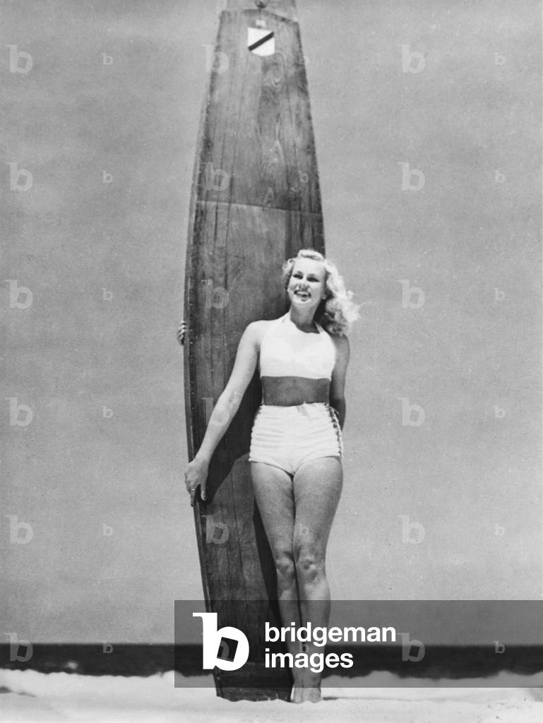 Surfer girl publicity shot with a vintage longboard (b/w photo)
