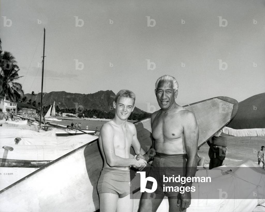 Duke Kahanamoku and surfer boy at Waikiki (b/w photo)
