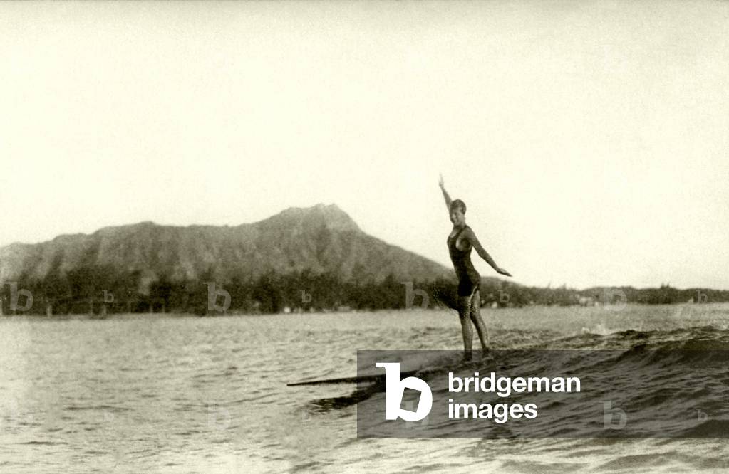 A surfer at Waikiki Beach, c.1920s (b/w photo)