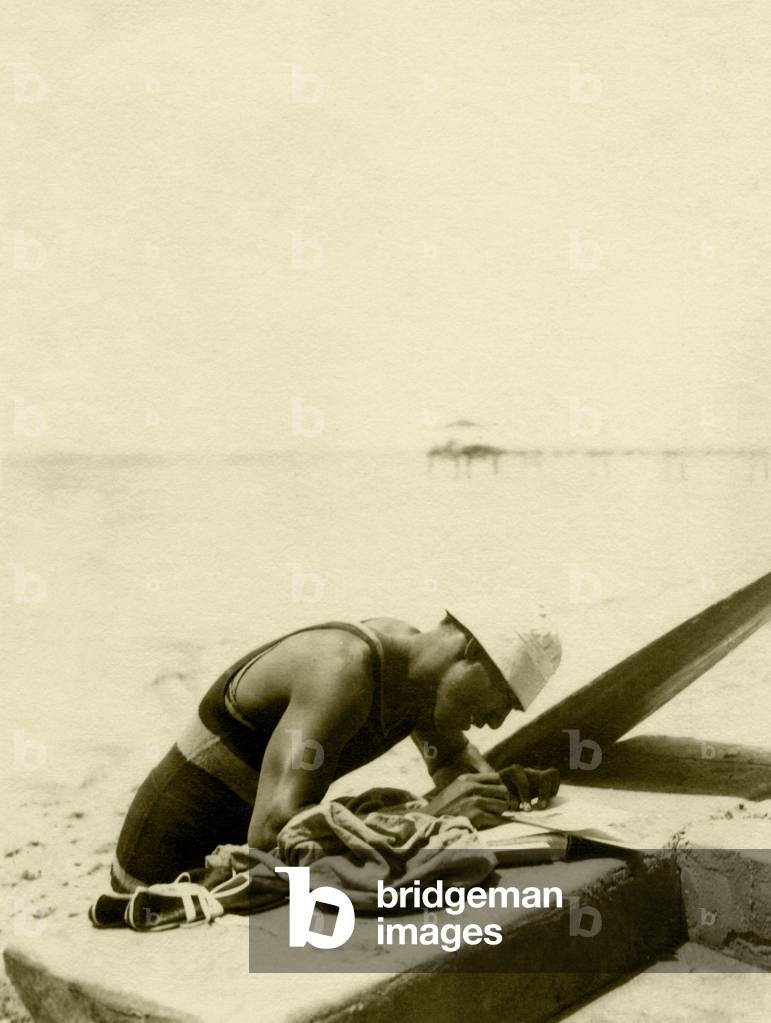 Duke Kahanamoku on the beach (b/w photo)