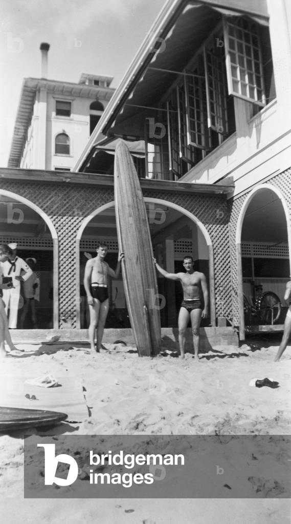 Surfers on the beach at Waikiki, c.1920s (b/w photo)