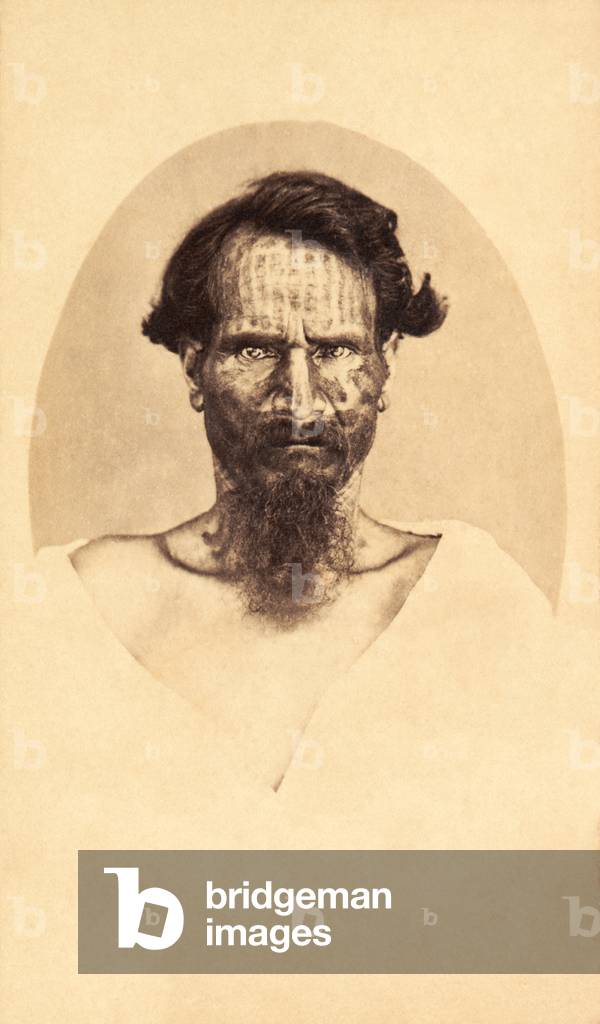 Carte-de-visite of a man with traditional tattoos from Papeete, Tahiti, photo by Mrs. S. Hoare, c.1910s (sepia photo)