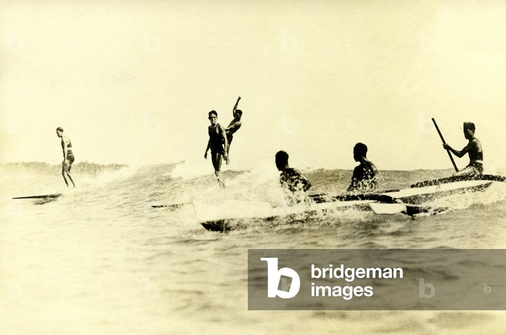 Surfers and canoers at Waikiki Beach, c.1920s (b/w photo)