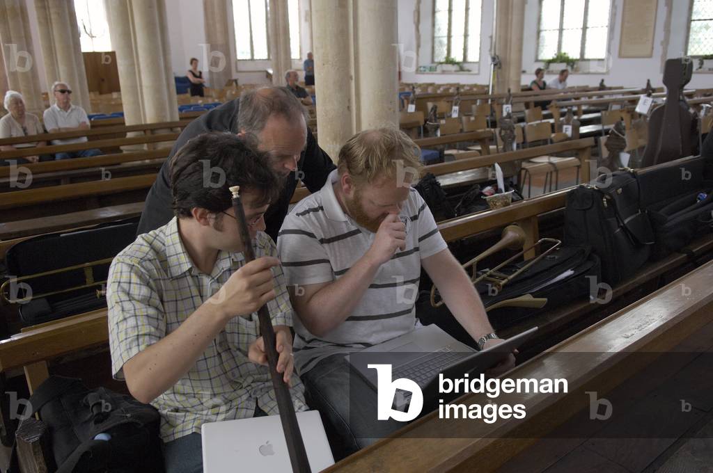 Musicians reading score on their laptops in Blythburgh church, Aldeburgh Festival, Suffolk, UK, June 2007