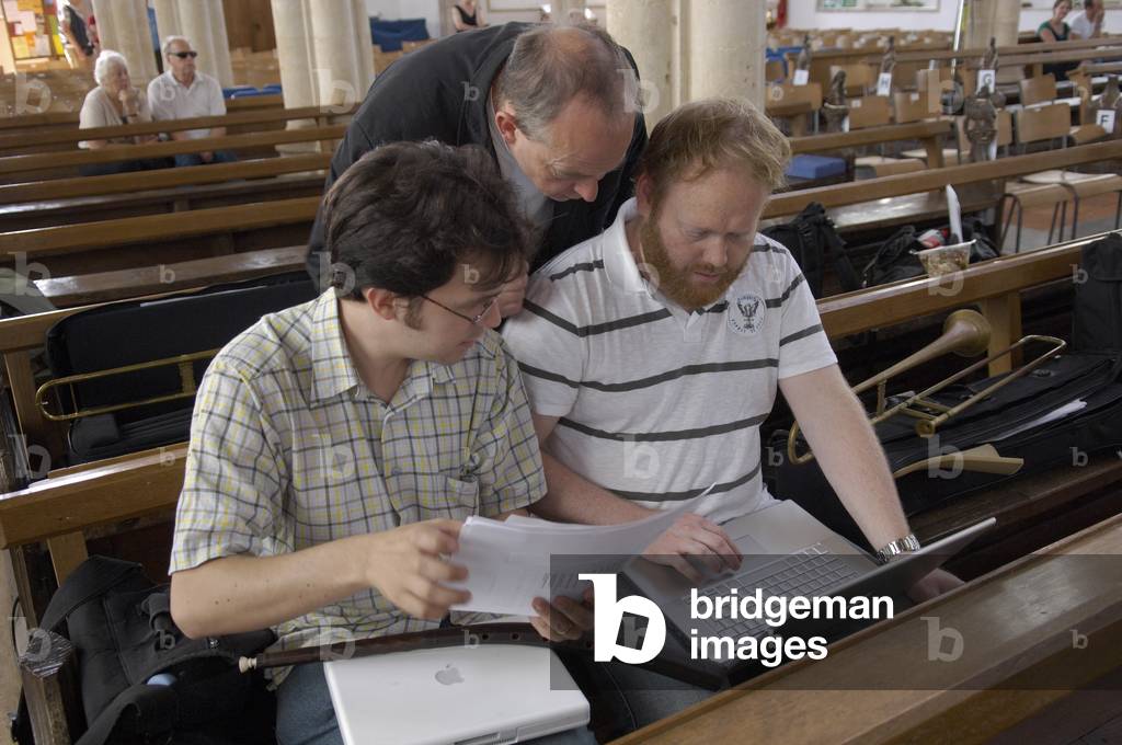 Musicians reading score on their laptops in Blythburgh church, Aldeburgh Festival, Suffolk, UK, June 2007