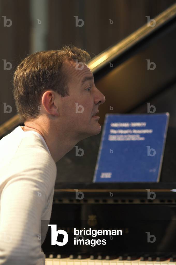 Andrew West - portrait of the British pianist sitting at a piano in Orford Church at the Aldeburgh Festival, 1 June 2005