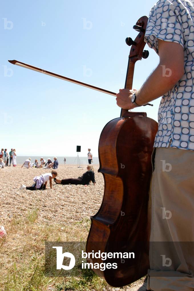 Aldeburgh, fringe show on the beach with man playing a cello Music festival 2004