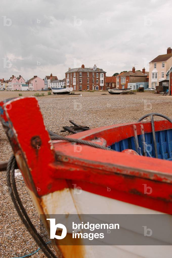 Aldeburgh, view of the beach with a boat in the foreground on the shore and houses in the near distance