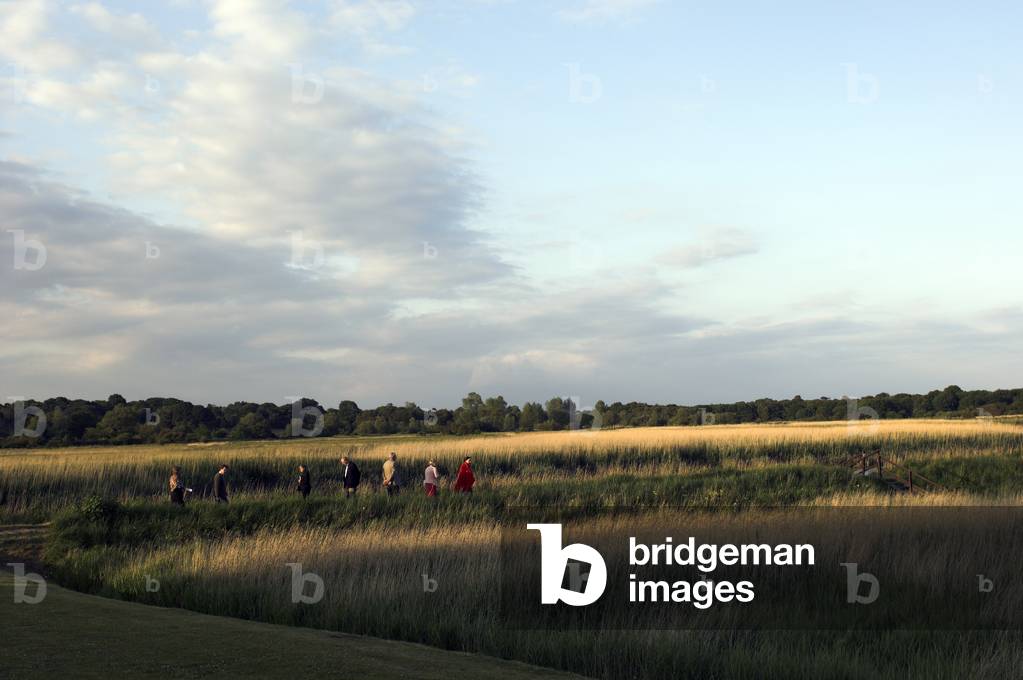 Snape - view over the marshes in the English countryside village with a group of walkers