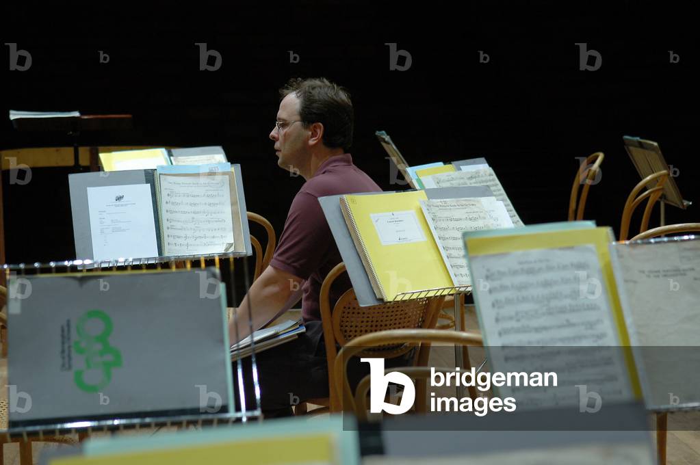 Oramo, Sakari sitting among the music stands at Aldeburgh Festival 2004