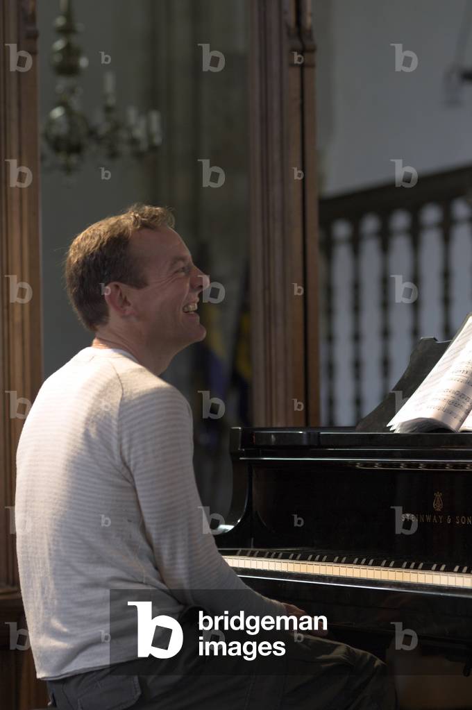 Andrew West - portrait of the British pianist sitting at a piano in Orford Church at the Aldeburgh Festival, 1 June 2005