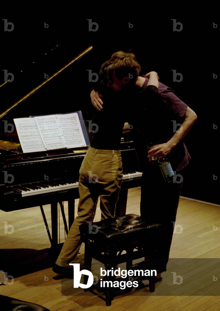 Singer Ian Bostridge and pianist Mitsuko Uchida hugging at end of rehearsal in Aldeburgh