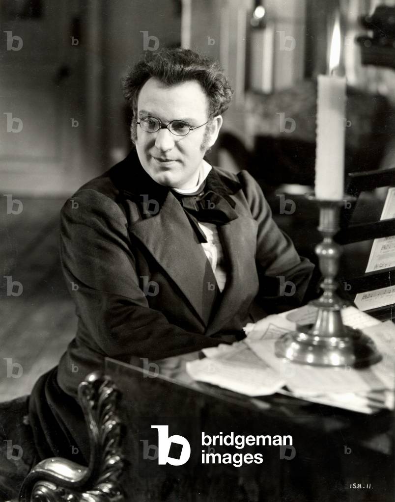 Richard Tauber as Franz Schubert in 'Blossom Time' playing piano by candlelight