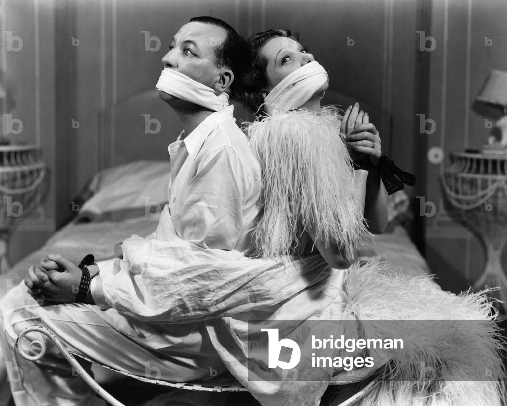 Noel Coward and Gertrude Lawrence as Toby and Stella Cartwright, tied up, for his play 'Ways and Means', c