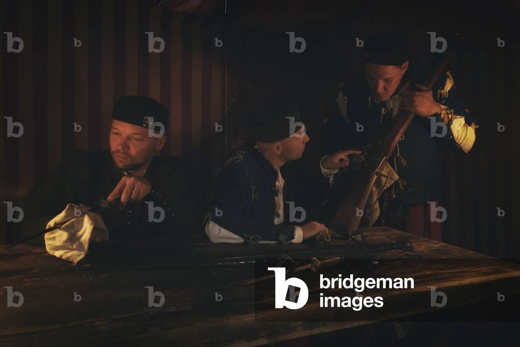 In the camp, at the fall of the night they clean the weapons, hypothesis reconstructive uses and customs Middle Ages Italy, Mondaino, Italy (photo)