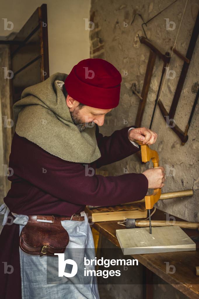 Reconstructive hypothesis of customs and customs, arts and crafts 14th century: The carpenter's workshop, Villafranca di Verona, Veneto, Italy (photo)