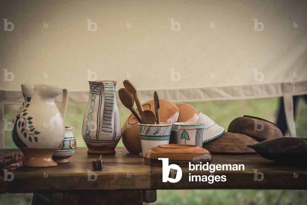 Second half XIV century: Camp: jugs, glasses, cutlery and plates on wooden table, Marimondo, Milan, Italy (photo)