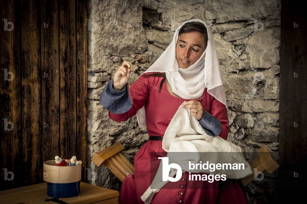Sewing woman, Daily life early 15th century, Northern Italy, Piedmont, Italy (photo)