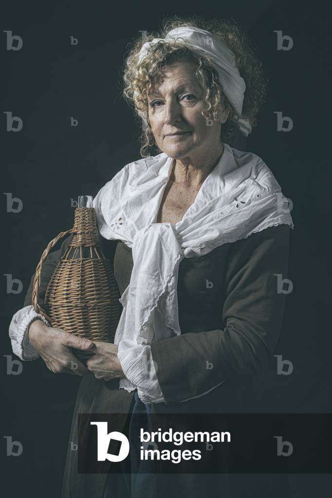 17th century, North Italy: country militia. Reconstructive hypothesis civil and military uses and customs. Portrait of a vivandiera with fiasco, Verrua Savoia, Turin, Piedmont, Italy (photo)