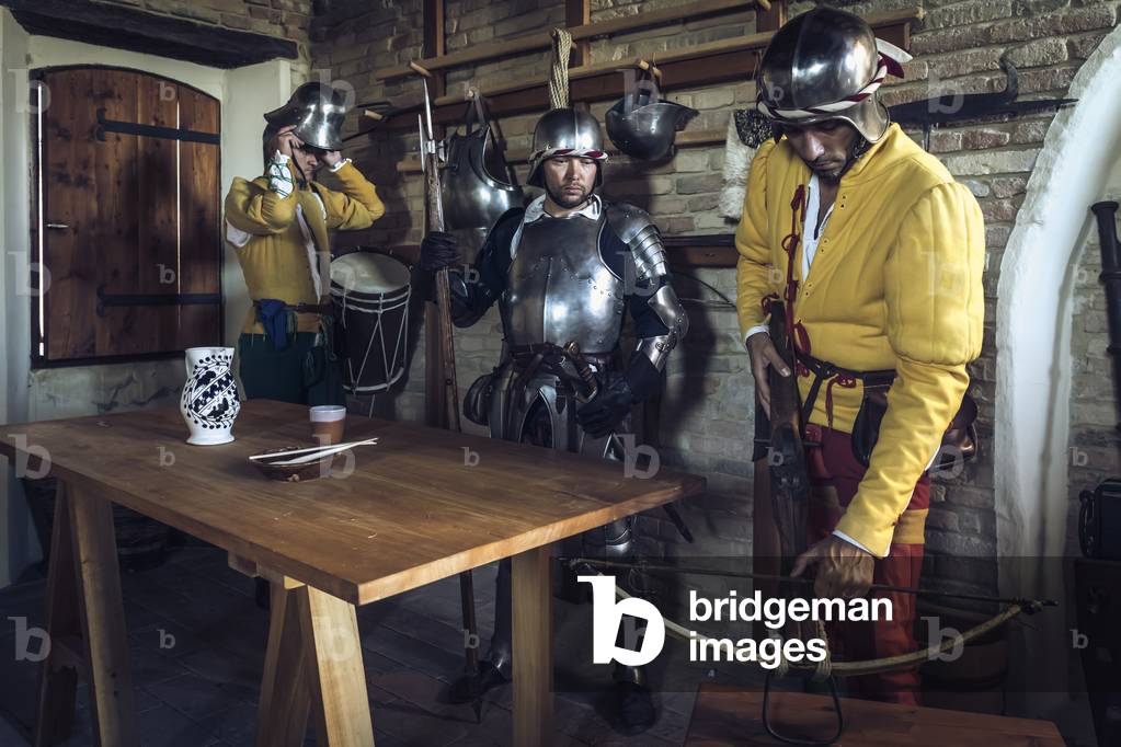 Three soldiers prepare for their watch turn, Hypothesis reconstructive uses and customs Middle Ages Italy, Mondaino, Italy (photo)
