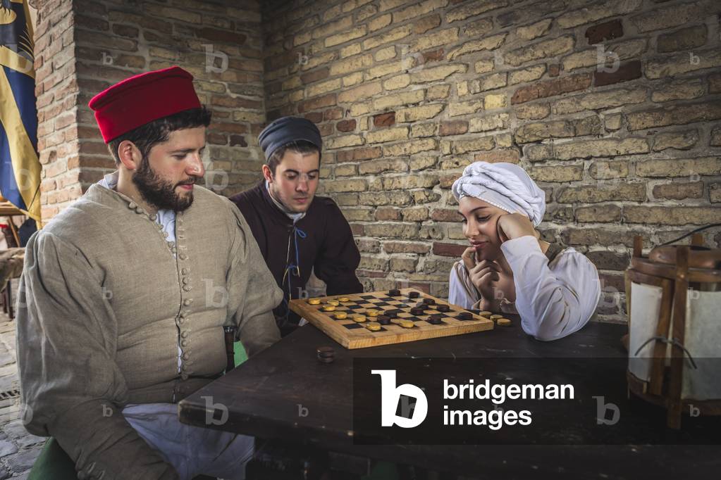 On a hot summer afternoon, under a porch you play checkers, Hypothesis reconstructive uses and customs Middle Ages Italy, Mondaino, Italy (photo)