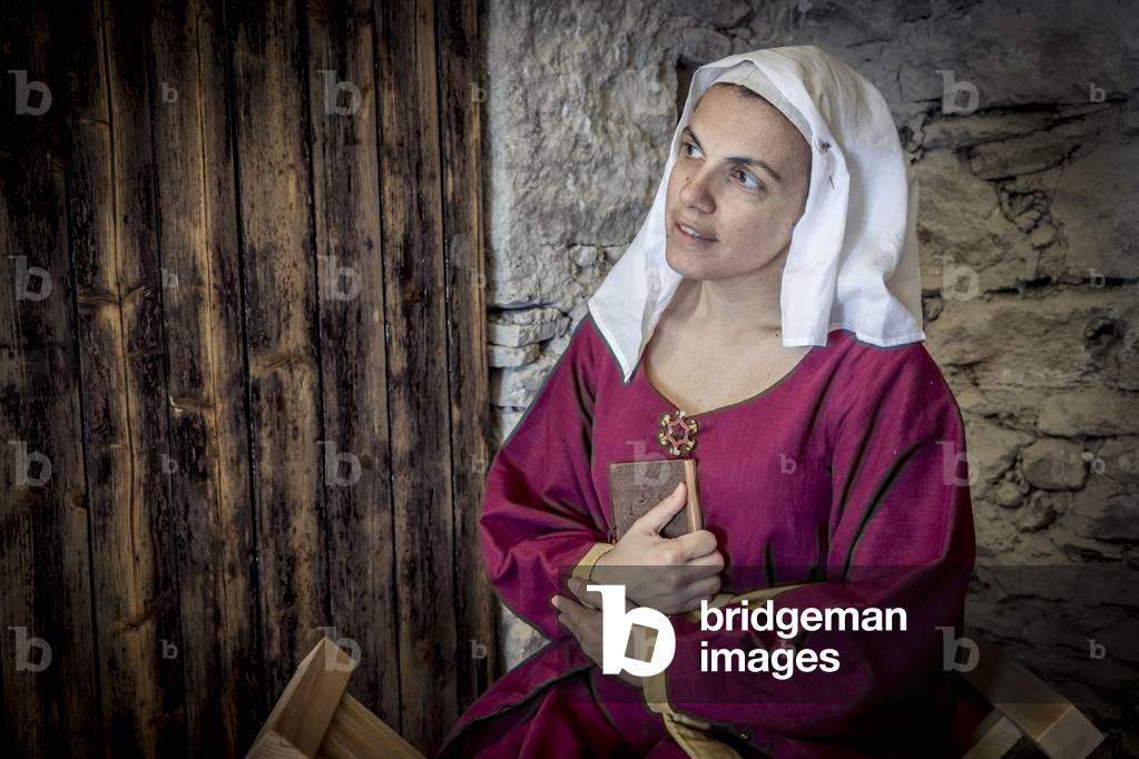 Reading poems of love, leads to daydreaming, Daily life early 15th century, Northern Italy, Piedmont, Italy (photo)