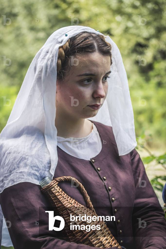 A.D. 1387, Portrait of a young food maker with white veil and wine fiasco, Terra del Sole, Forlì-Cesena, Emilia Romagna, Italy (photo)