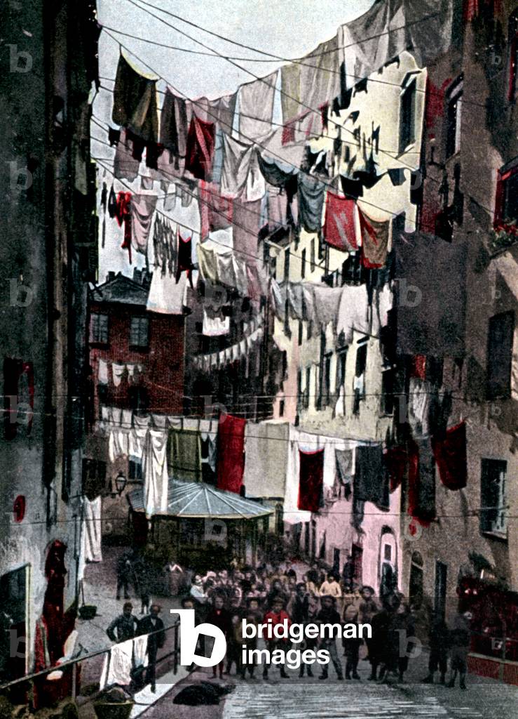 clothes line in the street in a poor area of Genoa, c. 1910, postcard