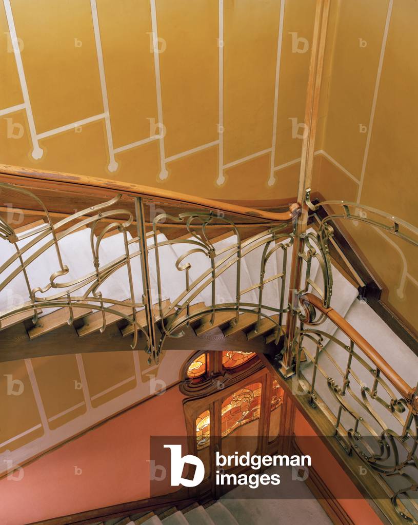 Stairwell below laylight showing ironwork wall mural and door between first and second floors, Maison and Atelier Horta, 23-25 Rue Americaine, Brussels, 1898-1901. Now the Horta Museum (photo)