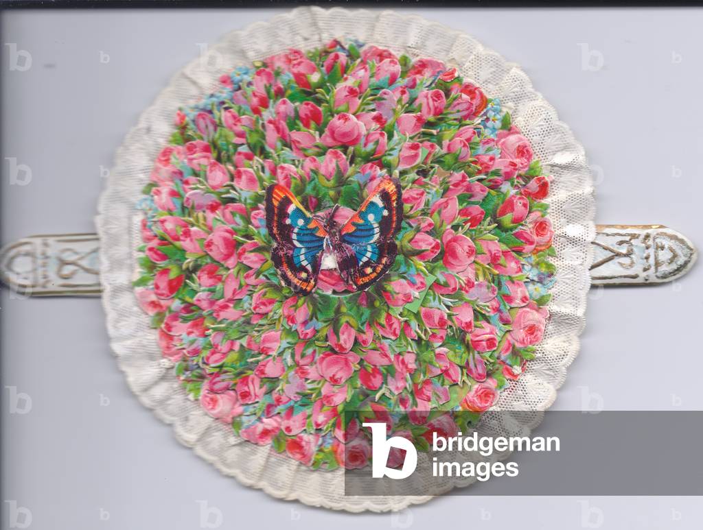 A Victorian lace edged mechanical greeting card of flowers tiered in a circle topped with a butterfly motif, c.1880 (colour litho)