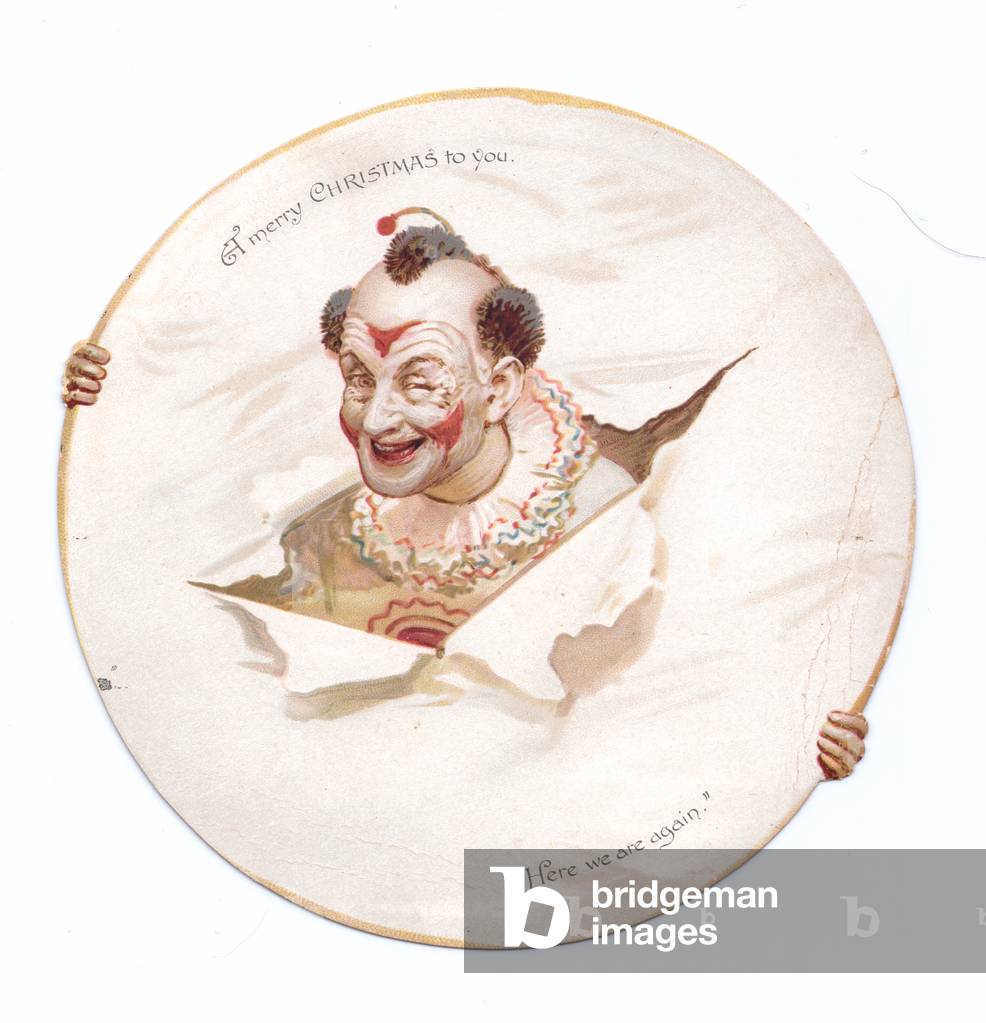 A Victorian oval shape Christmas card of a clown bursting through a paper hoop, c.1880 (colour litho)